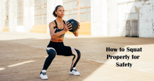 How to Squat Properly for Safety. Picture of a black female in a squatting position holding a small medicine ball.