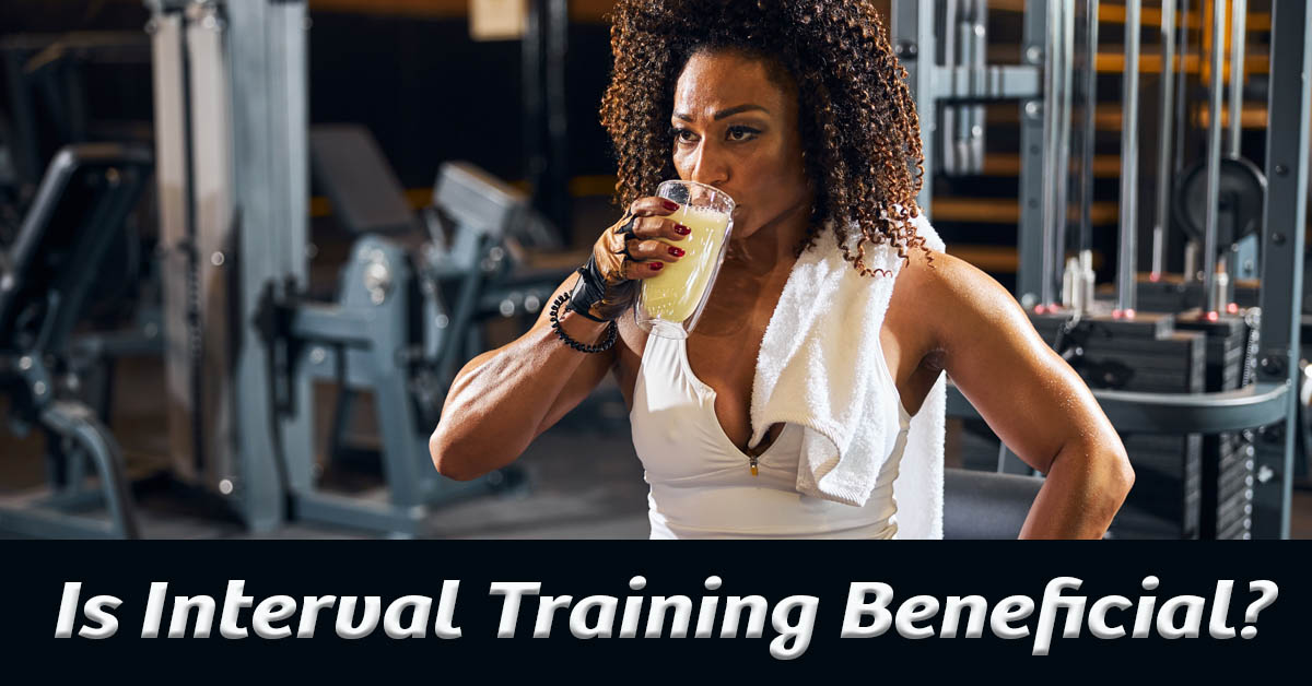 Is Interval Training Beneficial? Exploring the Benefits. Picture of a young black female drinking a beverage at a gym.
