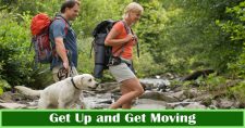 Get Up and Get Moving – for Health’s Sake! Picture of a young caucasian male and female hiking with a blond labrador retriever.